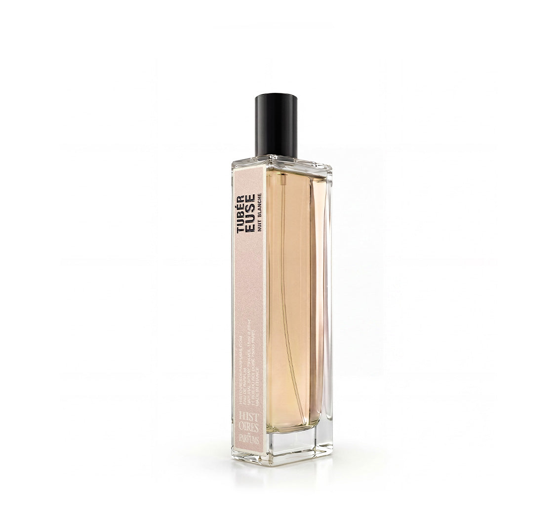 A Tubéreuse Nuit Blanche glass perfume bottle with a black cap on a white background.