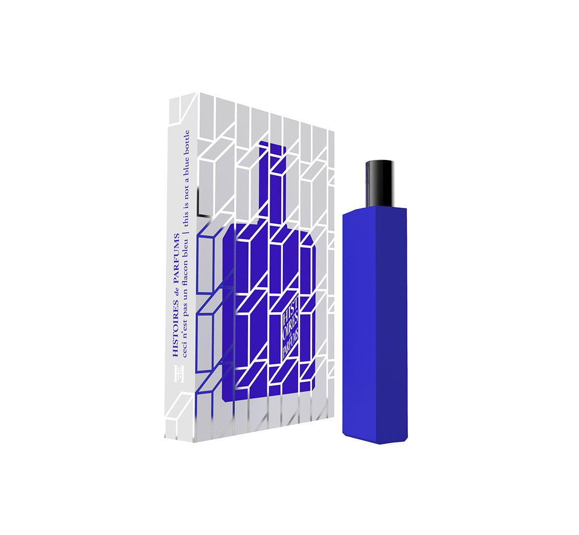 A perfume bottle of This is not a blue bottle 1/.1 - 15ml next to its packaging box.