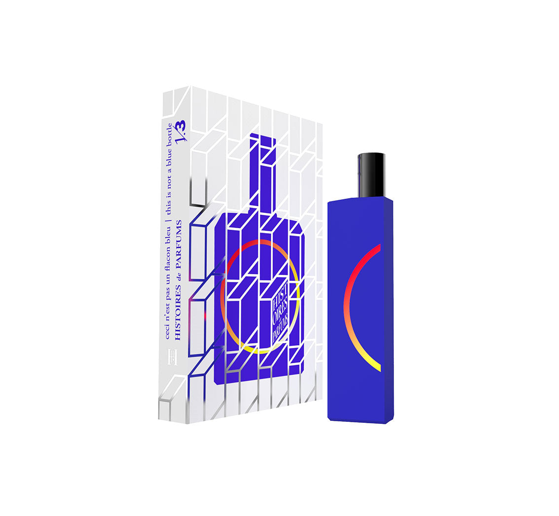 A perfume bottle of This is not a blue bottle 1/.3 - 15ml next to its packaging box. 